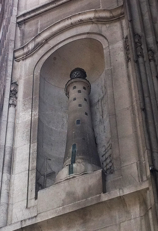 Ships in relief sail round lighthouse sculpture